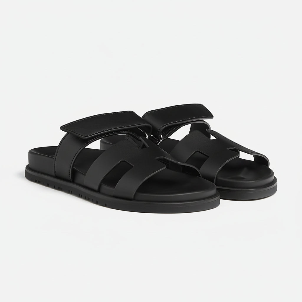 Pair of black sandals on a light gray background