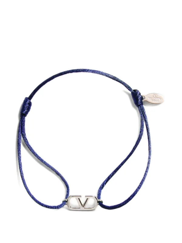 Blue braided bracelet with a silver clasp on a white background