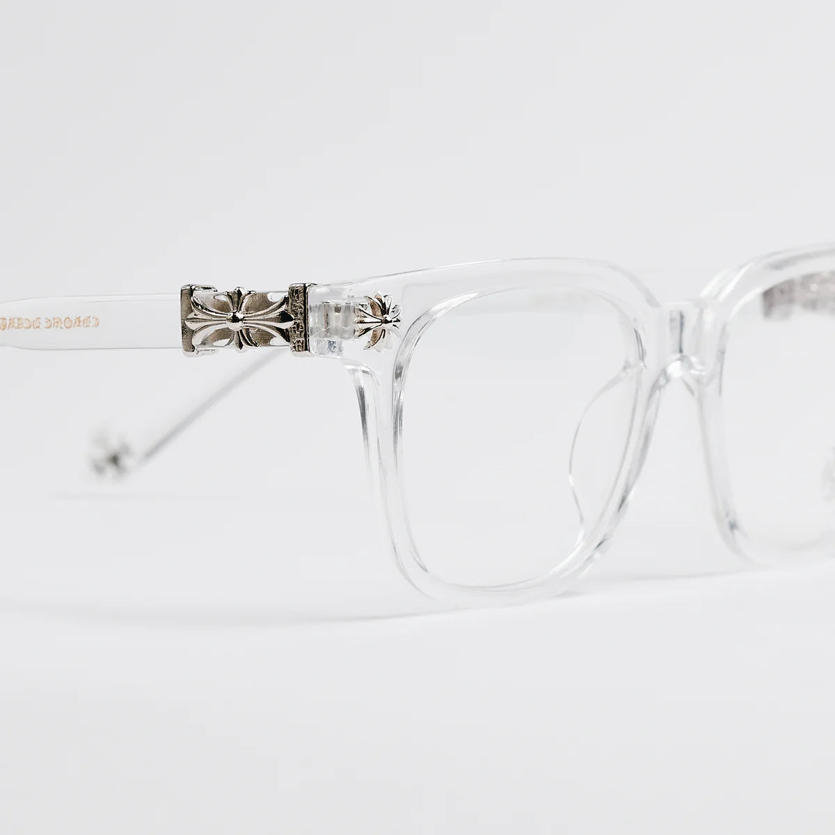 Clear eyeglasses with a decorative metal bridge on a white background