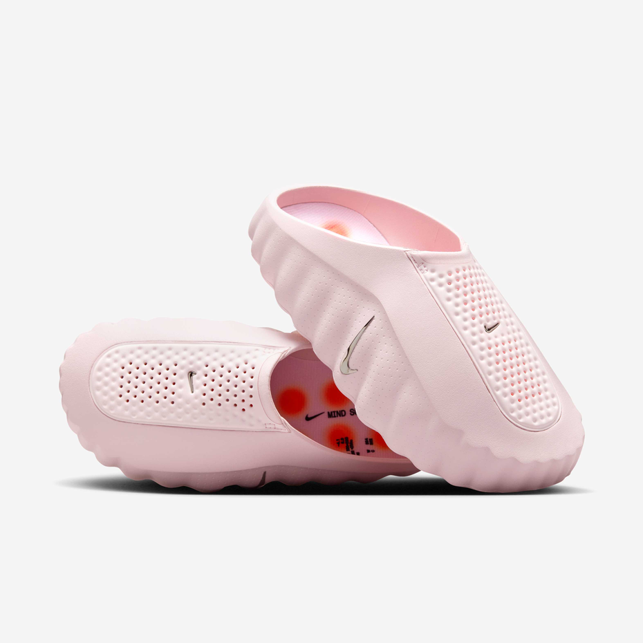 Pink Nike slides on a white background