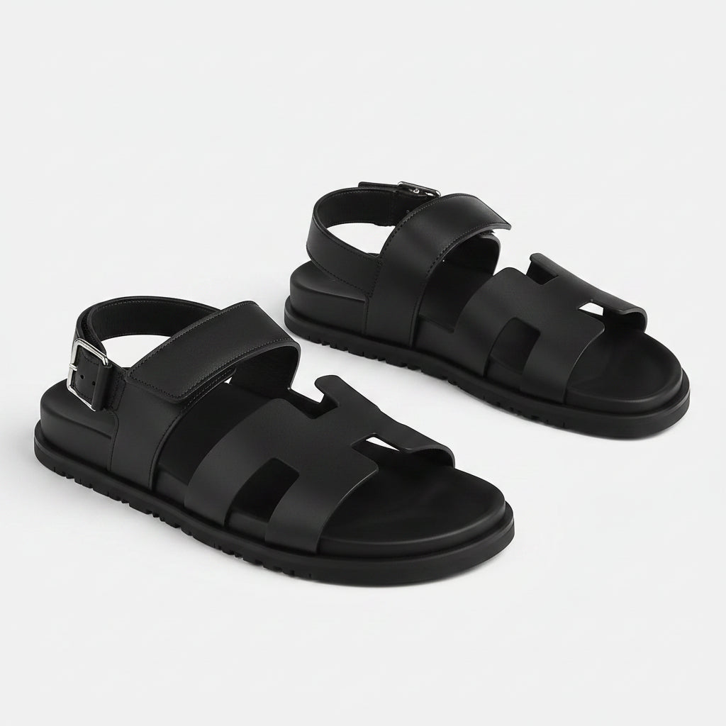 Black sandals with multiple straps on a white background