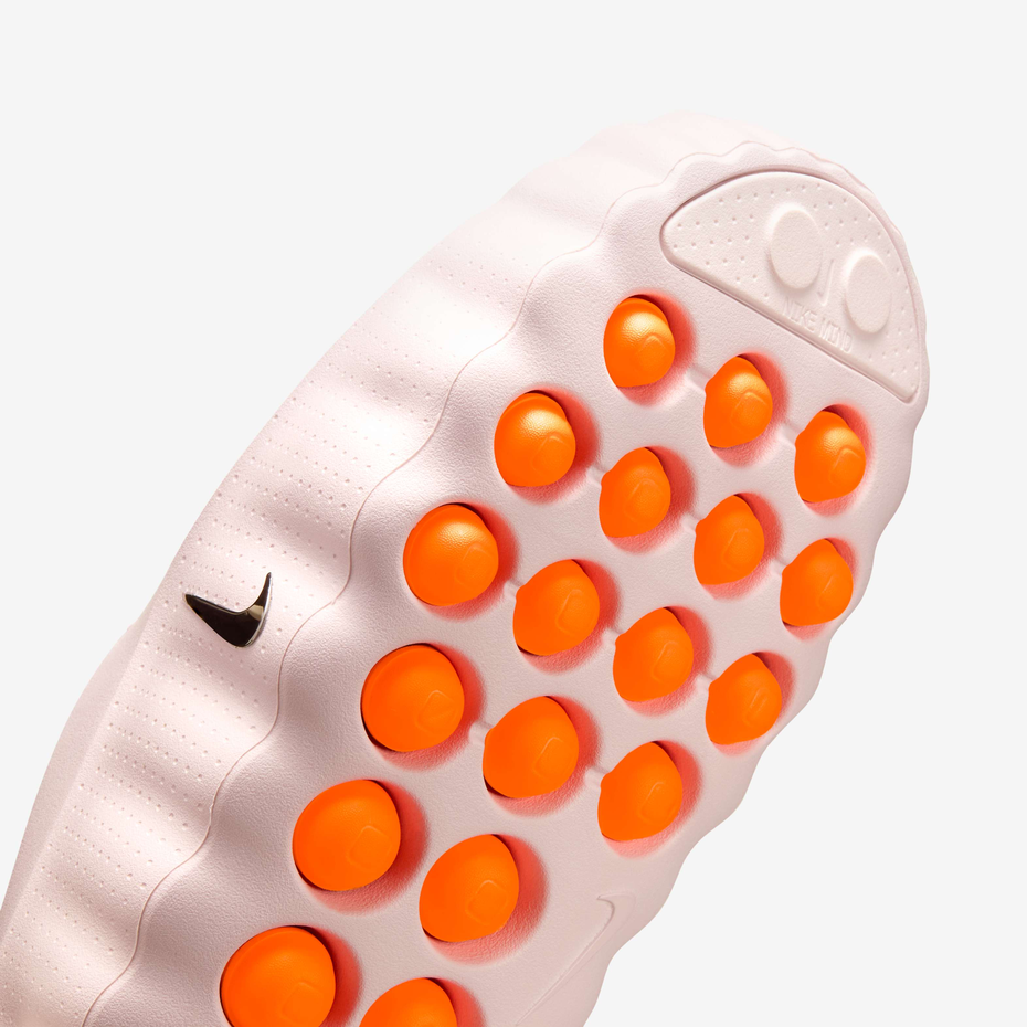 Pink toy with orange buttons on a white background