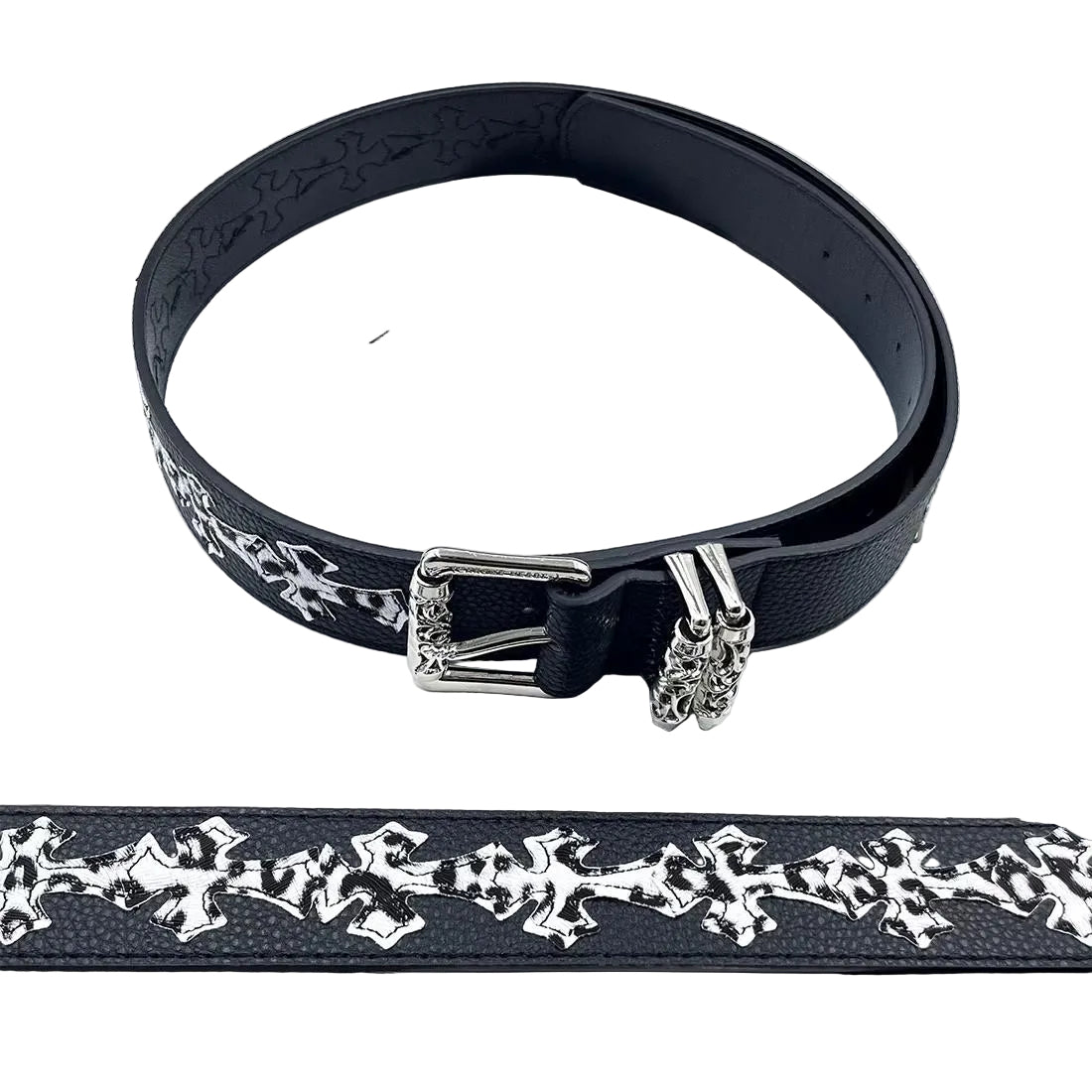 Black belt with silver floral patterns and a buckle on a magazine background