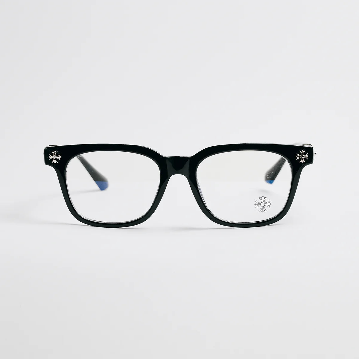 Black eyeglasses with decorative temples on a light gray background