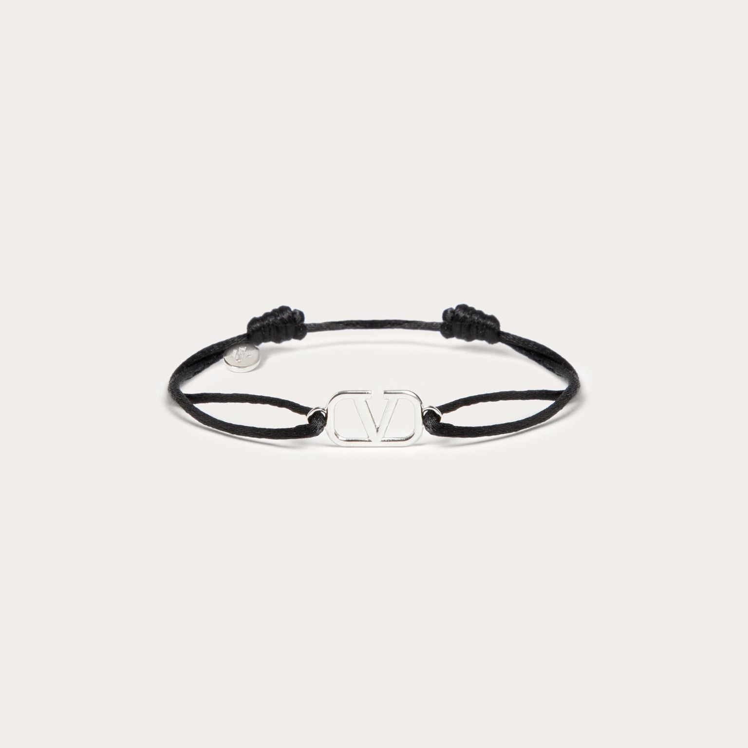 Black bracelet with a clasp on a white background