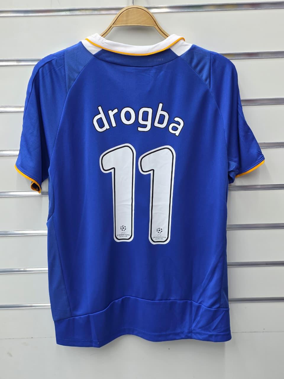 Blue sports jersey with 'drogba' and number '11' on a hanger against a metallic background