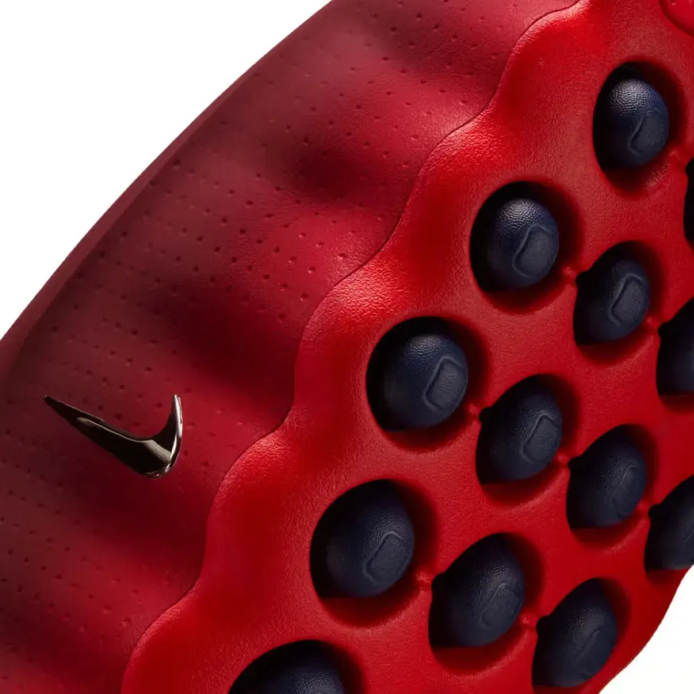 Close-up of a red and black shoe sole with Nike logo